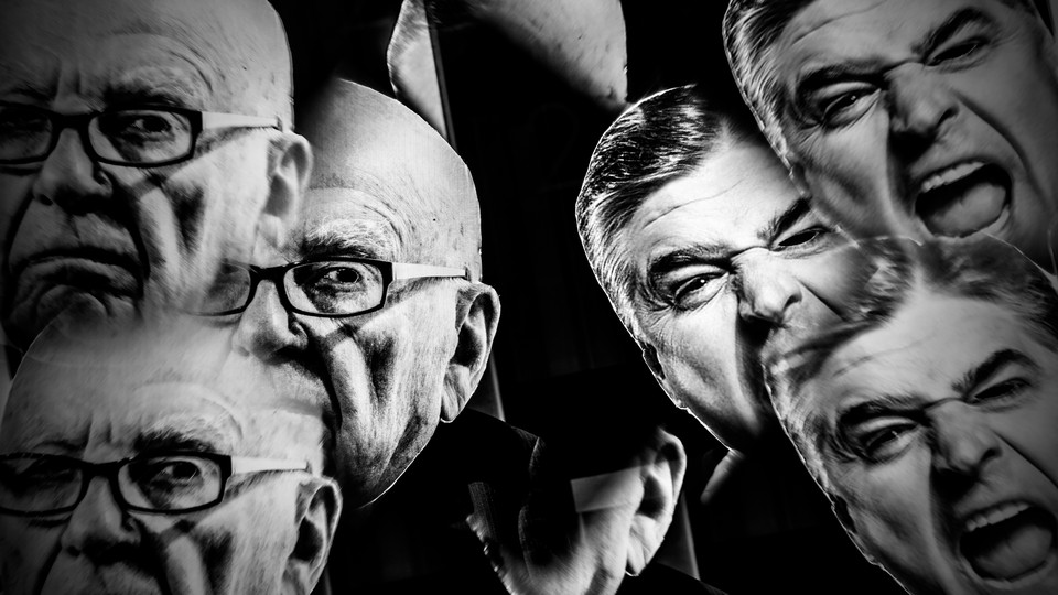 Black-and-white photo of protesters holding up masks of Rupert Murdoch and Sean Hannity