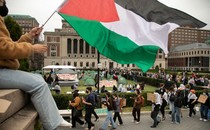 A photo of pro-Palestine protesters marching with signs on Columbia University's campus