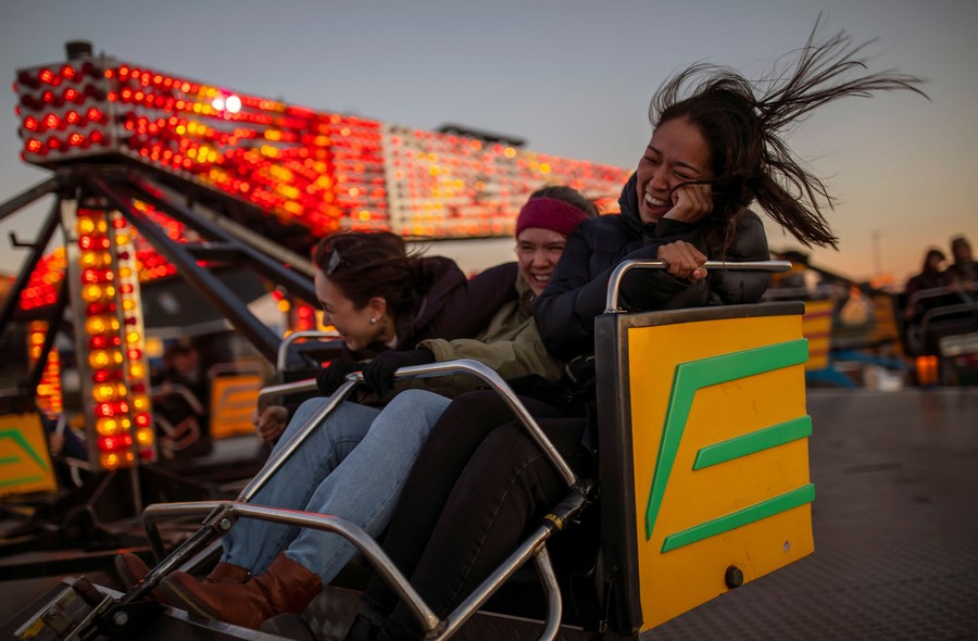 People enjoy a carnival ride.
