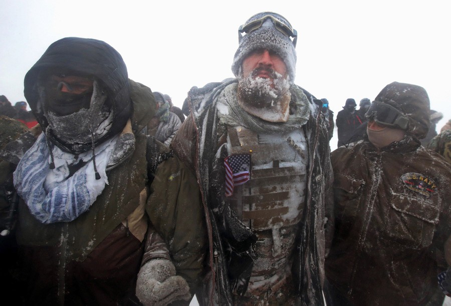 Despite blizzard conditions, military veterans march in support of the "water protectors" at the Oceti Sakowin Camp on December 5, 2016.