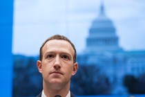 Mark Zuckerberg looks ahead in front of an image of Capitol Hill