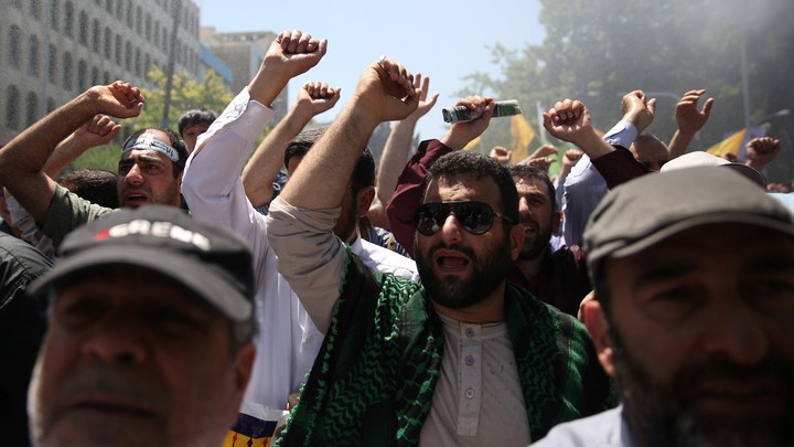 People attend a funeral for the victims of the June 7 attacks in Tehran.