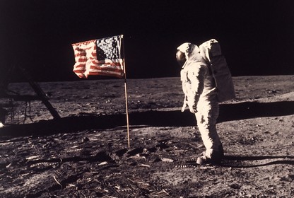 In a photo from 1969, Buzz Aldrin stands next to an American flag on the moon.