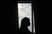 Silhouette of a girl against a window