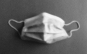 A fuzzy image of a surgical mask in gray scale