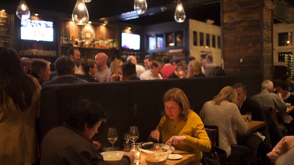 A couple sits at a table in a restaurant