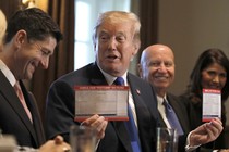 President Trump holds sample tax forms