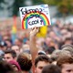 An attendee at an anti-racism concert in Chemnitz last month holds a poster that says "Tolerance is super cool."