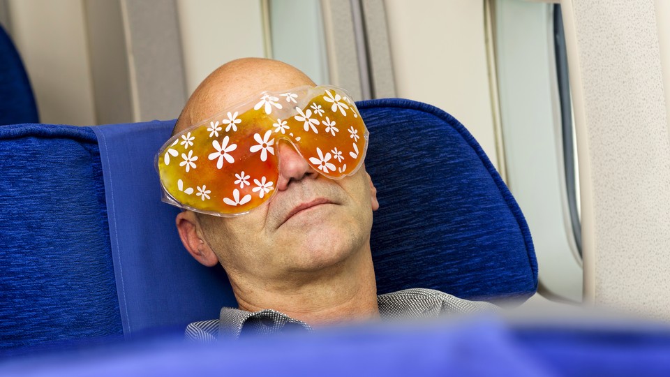 A man asleep on an airplane