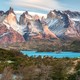 A distant view of a cluster of tall mountains with steep cliffs near their peaks