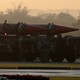 Workers cleaning missiles on transports