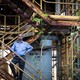 T. R. Chouhan stands on stairs at the ruins of the Union Carbide factory in Bhopal