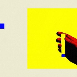 A hand holding an empty vial