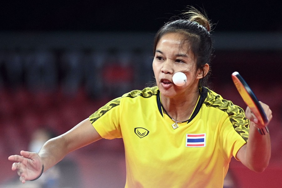 A table tennis player is struck on the cheek by a ball.