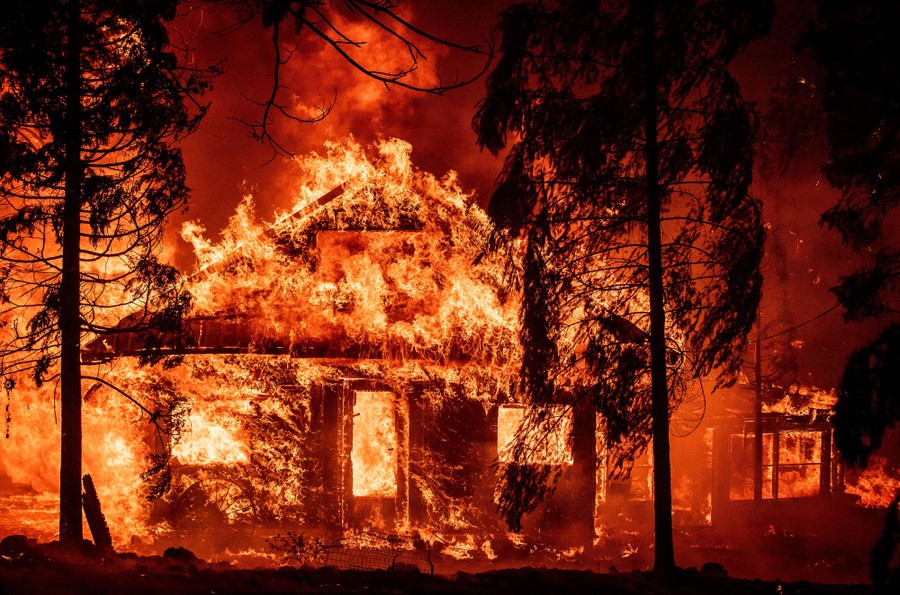 A house is completely consumed by flames.