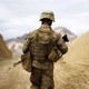 A U.S. Marine with his back to the camera walks through the town of Nabuk in southern Afghanistan.