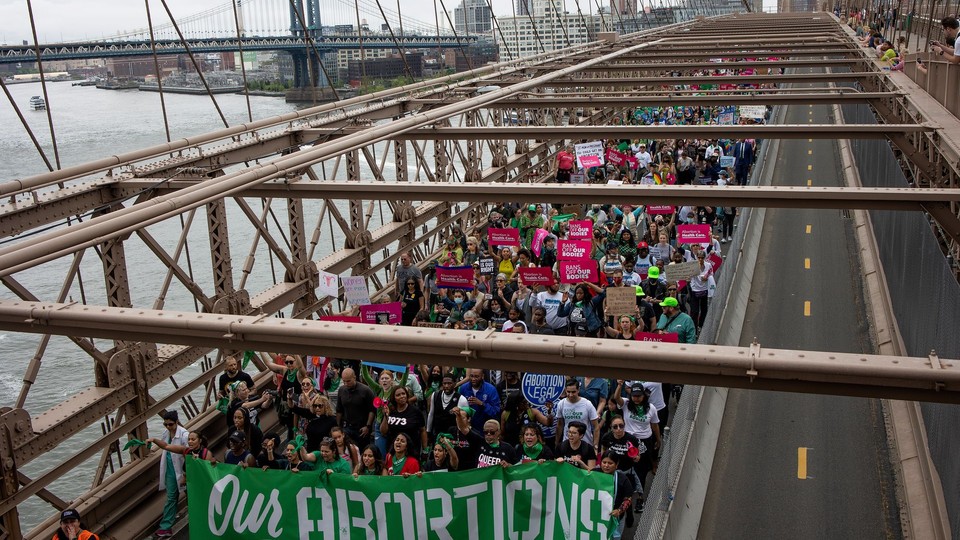 Abortion rights protestors crossing a bridge