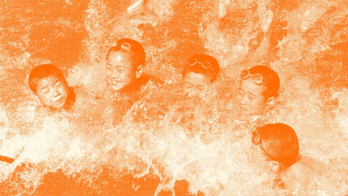 A group of 5 kids swims in water