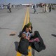 Afghan people waiting on the tarmac at the Kabul airport.