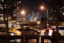 Cars driving at night in front of the Queensboro Bridge