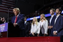 Donald Trump speaks at a campaign event, standing in front of Tiffany Trump, Lara Trump, Eric Trump, and Donald Trump Jr.