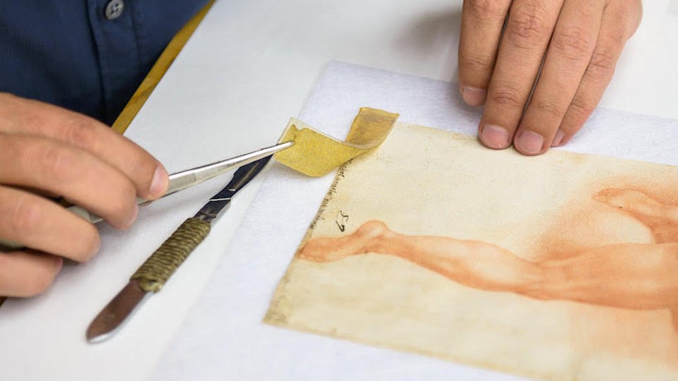 Yellow tape being peeled off a sketch of a leg 