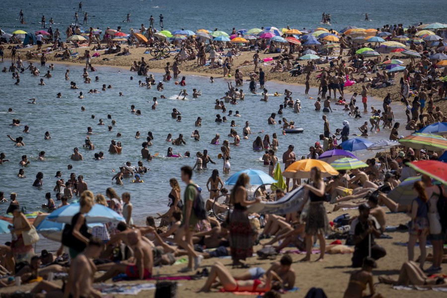 A view of a crowded beach during the summer.