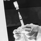 A nurse prepares a dose of vaccine in a syringe.