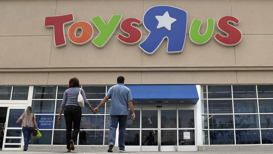 Two shoppers walk into a Toys "R" Us store