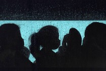 silhouettes of refugees on a bus