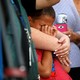A young boy cries in a woman's embrace at a prayer vigil following the mass shooting in Las Vegas. 