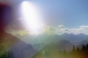 Photograph of a mountain range on a sunny day, image quality looks like it's being seen under a kaleidoscope