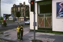 photo of two young boys standing on a street corner in Glasgow