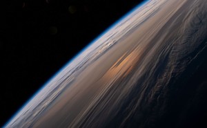 A view of the horizon and clouds at sunrise from Earth orbit