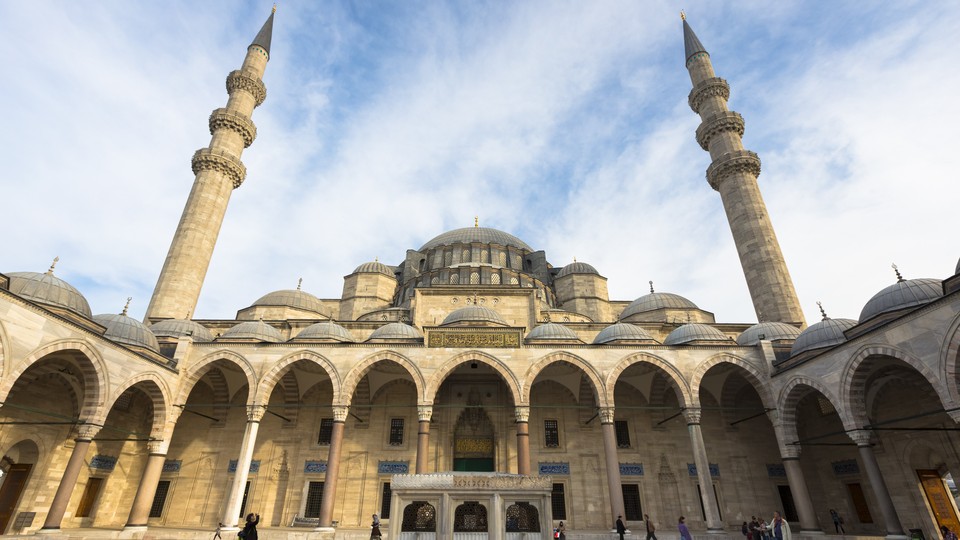 Tourists explore the courtyard of Suleymaniye Mosque in Istanbul.