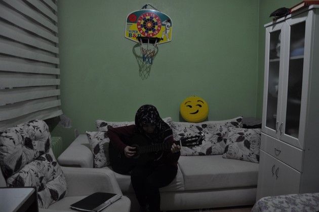 Fatma, a 16-year-old girl from a Gulenist family, strums her guitar (Lauren Bohn)