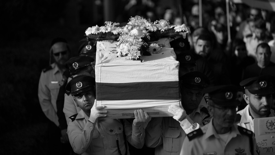 Israeli police officers carry the coffin for their slain colleague.