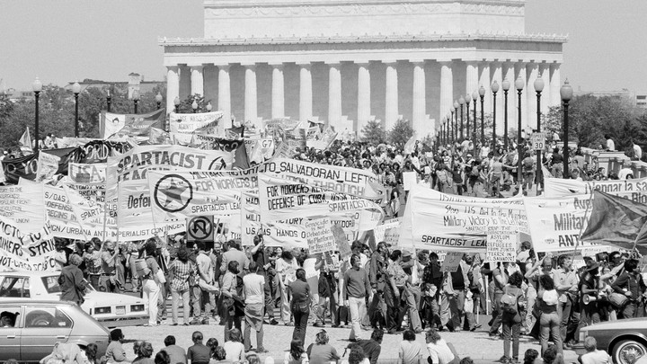 With the Lincoln Memorial in the background, anti-war marchers cross the Memorial Bridge.