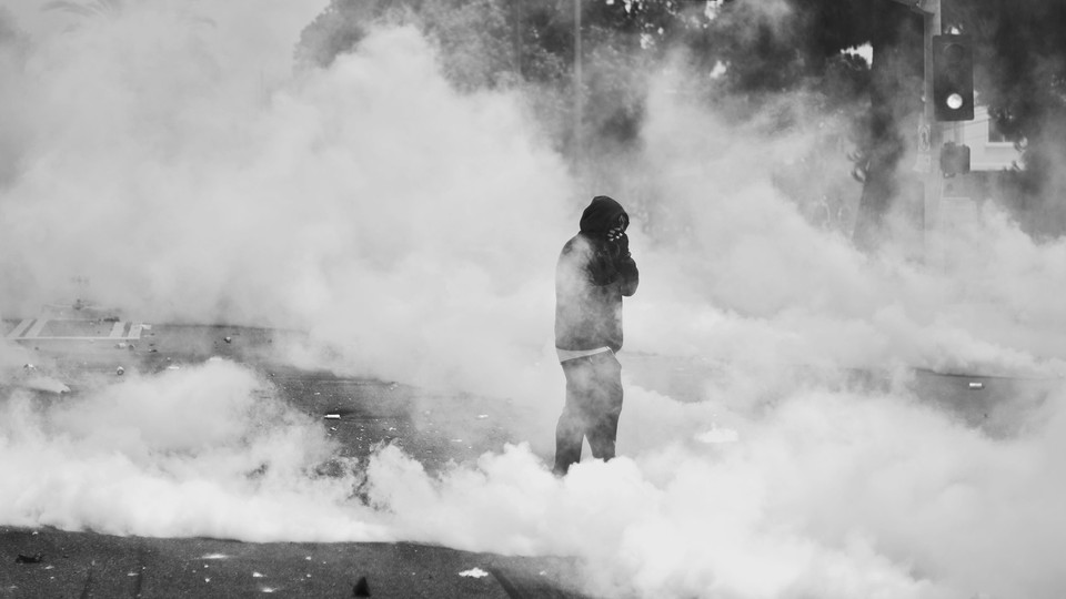 A new photo of a protester in L.A. amid tear-gas clouds
