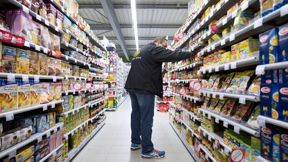 An employee works in a Carrefour grocery store in Riaille, France