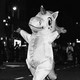 A person dressed as a unicorn parading down the street in New York city
