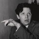 Portrait of Welsh poet Dylan Thomas (1914–1953) sitting in an unidentified bar, early 1950s.