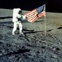 Charles "Pete" Conrad Jr. stands with the U.S. flag on the lunar surface during the Apollo 12 mission in 1969.