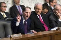 Democratic Senator Ron Wyden of Oregon argues with Republican Orrin Hatch of Utah during a committee debate over taxes.