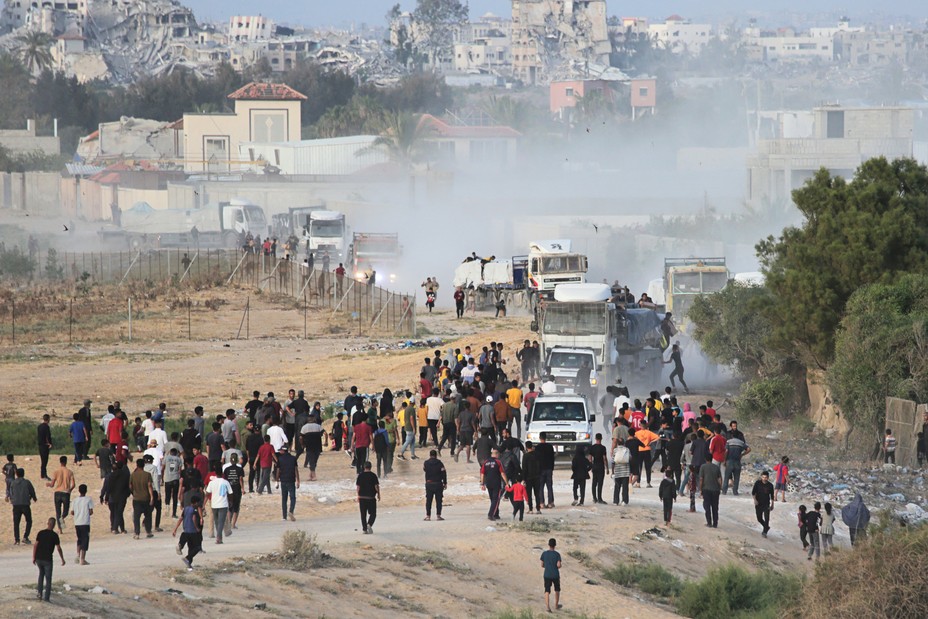 Picture of Palestinians rushing trucks with international aid at the US-built Trident Pier near Nuseirat in central Gaza during the ongoing conflict between Israel and Hamas.