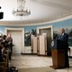 President Joe Biden at a press conference in front of many cameras and reporters