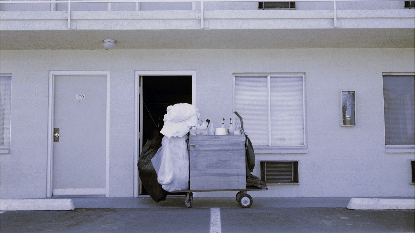 A motel cleaning cart in front of an open door