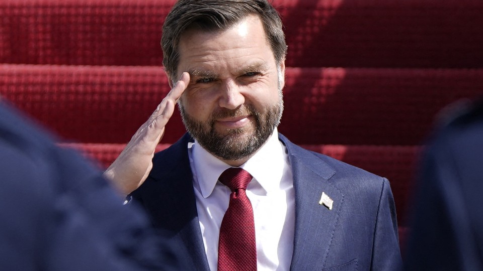 J. D. Vance smiles as he does a salute