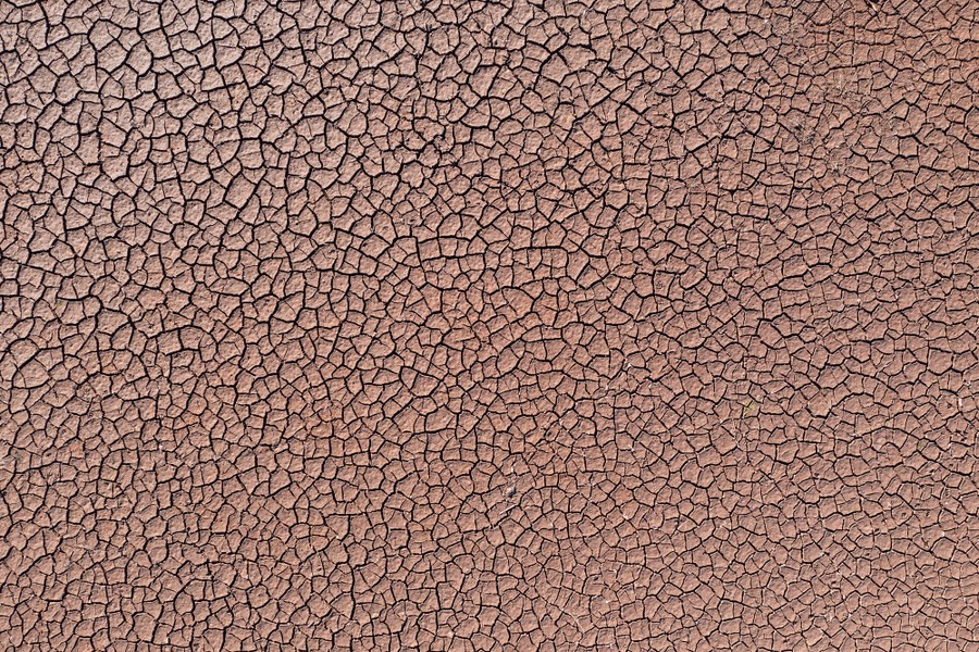 An aerial view of the cracked mud of a dry reservoir