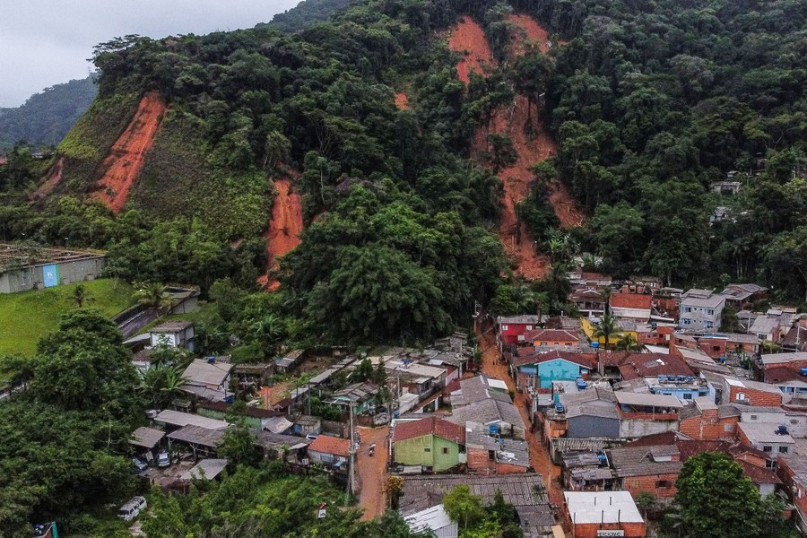 Mudslides in a steep forested hill above a small town